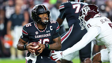 Nov 2, 2024; Columbia, South Carolina, USA; South Carolina Gamecocks quarterback LaNorris Sellers (16) eludes a sack by Texas A&M Aggies linebacker Scooby Williams (0) in the first quarter at Williams-Brice Stadium. Mandatory Credit: Jeff Blake-Imagn Images