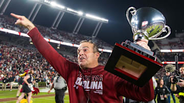 Nov 16, 2024; Columbia, South Carolina, USA; South Carolina Gamecocks head coach Shane Beamer celebrates beating the Missouri Tigers at Williams-Brice Stadium. He is holding the Mayors Cup, given to the winner of the South Carolina-Missouri game. Mandatory Credit: Jeff Blake-Imagn Images