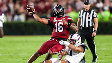 Sep 6, 2025; Columbia, South Carolina, USA; South Carolina Gamecocks quarterback LaNorris Sellers (16) passes as he is brought down by South Carolina State Bulldogs defensive end Mike Lunz (11) in the second quarter at Williams-Brice Stadium. Mandatory Credit: Jeff Blake-Imagn Images