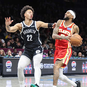 Oct 29, 2025; Brooklyn, New York, USA; Atlanta Hawks guard Nickeil Alexander-Walker (7) looks to drive past Brooklyn Nets forward Jalen Wilson (22) in the third quarter at Barclays Center. Mandatory Credit: Wendell Cruz-Imagn Images