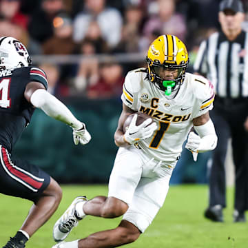 Nov 16, 2024; Columbia, South Carolina, USA; Missouri Tigers wide receiver Theo Wease Jr. (1) runs after a reception against South Carolina Gamecocks defensive back Jalon Kilgore (24) in the second half at Williams-Brice Stadium. Mandatory Credit: Jeff Blake-Imagn Images