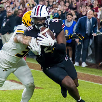 Nov 16, 2024; Columbia, South Carolina, USA; South Carolina Gamecocks tight end Michael Smith (20) makes a touchdown reception as Missouri Tigers linebacker Chuck Hicks (30) defends in the second half at Williams-Brice Stadium. Mandatory Credit: Jeff Blake-Imagn Images