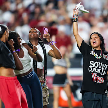 Sep 6, 2025; Columbia, South Carolina, USA; South Carolina Gamecocks head women’s basketball coach Dawn Staley leads the crowd in a cheer before the game against the South Carolina State Bulldogs at Williams-Brice Stadium. Mandatory Credit: Jeff Blake-Imagn Images