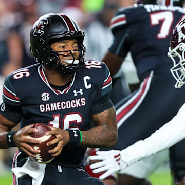 Nov 2, 2024; Columbia, South Carolina, USA; South Carolina Gamecocks quarterback LaNorris Sellers (16) eludes a sack by Texas A&M Aggies linebacker Scooby Williams (0) in the first quarter at Williams-Brice Stadium. Mandatory Credit: Jeff Blake-Imagn Images