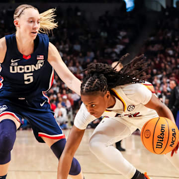 Gamecocks forward Chloe Kitts drives around Huskies guard Paige Bueckers. 