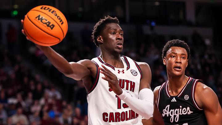 Feb 1, 2025; Columbia, South Carolina, USA; South Carolina Gamecocks guard Morris Ugusuk (15) passes around Texas A&M Aggies forward Pharrel Payne (21) in the first half at Colonial Life Arena. Mandatory Credit: Jeff Blake-Imagn Images