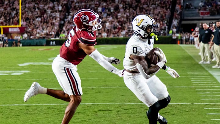 Sep 13, 2025; Columbia, South Carolina, USA; Vanderbilt Commodores wide receiver Junior Sherrill (0) gets around South Carolina Gamecocks defensive back Brandon Cisse (15) for a touchdown in the second quarter at Williams-Brice Stadium. Mandatory Credit: Jeff Blake-Imagn Images