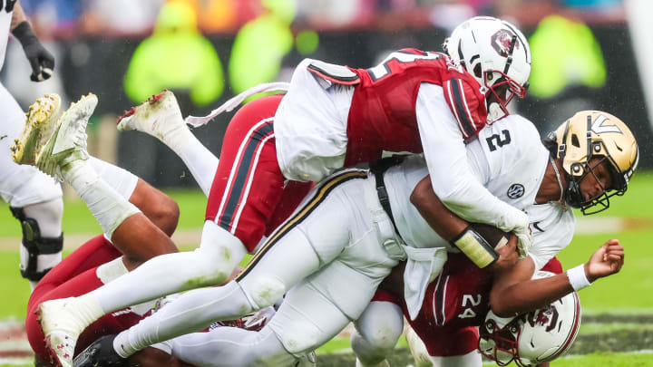 Nov 11, 2023; Columbia, South Carolina, USA; Vanderbilt Commodores quarterback Walter Taylor (2) is tackled by South Carolina Gamecocks linebacker Bam Martin-Scott (22) in the second quarter at Williams-Brice Stadium. Mandatory Credit: Jeff Blake-USA TODAY Sports