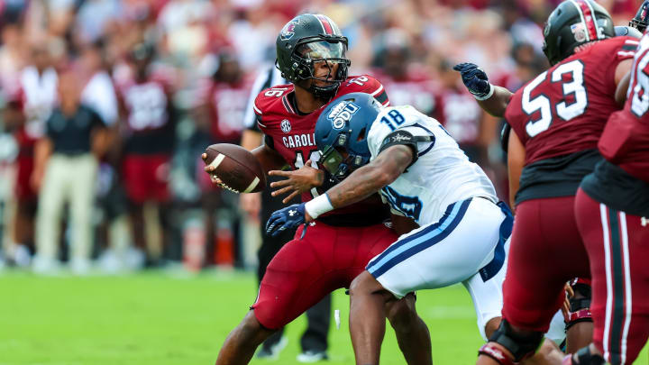 Aug 31, 2024; Columbia, South Carolina, USA; South Carolina Gamecocks quarterback LaNorris Sellers (16) is sacked by Old Dominion Monarchs linebacker Mario Thompson (18) in the first quarter at Williams-Brice Stadium. Mandatory Credit: Jeff Blake-USA TODAY Sports