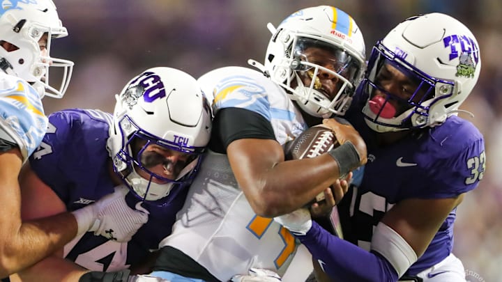 TCU defenders wrap up the Long Island Quarterback for a tackle. 