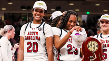 Mar 2, 2025; Columbia, South Carolina, USA; South Carolina Gamecocks forward Sania Feagin (20) and guard Bree Hall (23) try on SEC Championship hats after defeating the Kentucky Wildcats at Colonial Life Arena. Mandatory Credit: Jeff Blake-Imagn Images