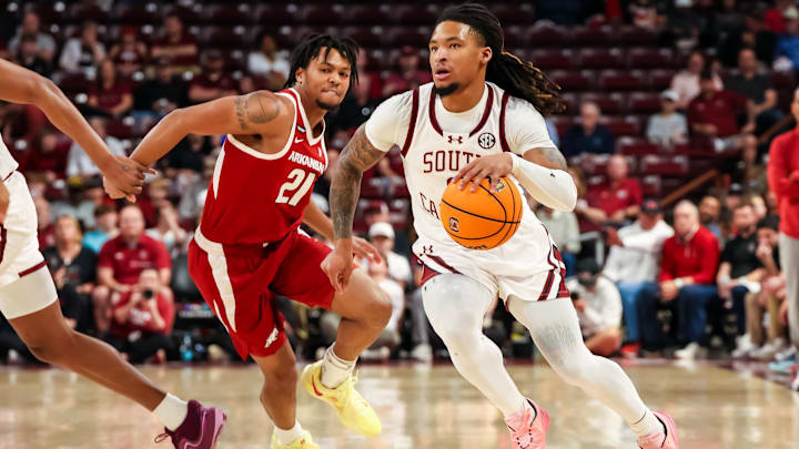 Mar 1, 2025; Columbia, South Carolina, USA; South Carolina Gamecocks guard Jamarii Thomas (6) drives past Arkansas Razorbacks guard D.J. Wagner (21) in the first half at Colonial Life Arena. Mandatory Credit: Jeff Blake-Imagn Images