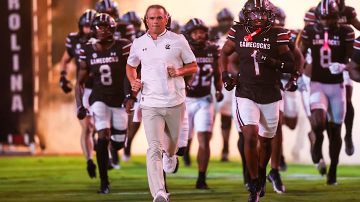 Sep 27, 2025; Columbia, South Carolina, USA; South Carolina Gamecocks head coach Shane Beamer leads his team onto the field during the Gamecocks 2001 entrance before their game against the Kentucky Wildcats at Williams-Brice Stadium. Mandatory Credit: Jeff Blake-Imagn Images
