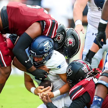 Aug 31, 2024; Columbia, South Carolina, USA; Old Dominion Monarchs quarterback Grant Wilson (7) is sacked by South Carolina Gamecocks edge Dylan Stewart (6) and edge Kyle Kennard (5) in the second quarter at Williams-Brice Stadium. Mandatory Credit: Jeff Blake-Imagn Images