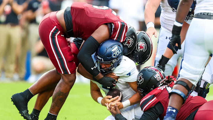 Aug 31, 2024; Columbia, South Carolina, USA; Old Dominion Monarchs quarterback Grant Wilson (7) is sacked by South Carolina Gamecocks edge Dylan Stewart (6) and edge Kyle Kennard (5) in the second quarter at Williams-Brice Stadium. Mandatory Credit: Jeff Blake-Imagn Images