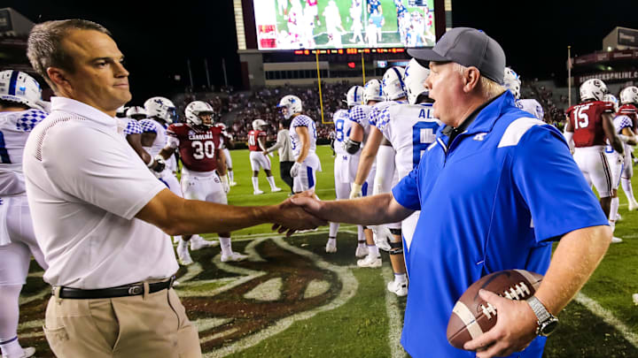 Sep 25, 2021; Columbia, South Carolina, USA: South Carolina Gamecocks head coach Shane Beamer shakes hands with Kentucky Wildcats head coach Mark Stoops following a Kentucky victory at Williams-Brice Stadium. Mandatory Credit: Jeff Blake-Imagn Images