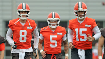 Cleveland Browns quarterbacks Kenny Pickett, Dillon Gabriel, and Joe Flacco warm up during OTAs