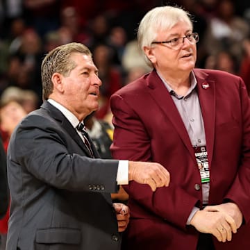 Feb 26, 2023; Columbia, South Carolina, USA; South Carolina Gamecocks athletics director Ray Tanner, left, and school president Michael Amiridis chat following South Carolina Gamecocks women   s basketball win over the Georgia Lady Bulldogs at Colonial Life Arena. Mandatory Credit: Jeff Blake-Imagn Images