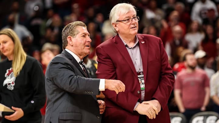 Feb 26, 2023; Columbia, South Carolina, USA; South Carolina Gamecocks athletics director Ray Tanner, left, and school president Michael Amiridis chat following South Carolina Gamecocks women   s basketball win over the Georgia Lady Bulldogs at Colonial Life Arena. Mandatory Credit: Jeff Blake-Imagn Images