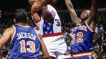 Unknown date; Philadelphia, PA, USA; FILE PHOTO; Philadelphia 76ers forward Charles Barkley (32) shoots over New York Knicks forward Xavier McDaniel (32) at the Spectrum. Mandatory Credit: Imagn Images