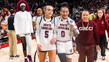 Jan 24, 2025; Columbia, South Carolina, USA; South Carolina Gamecocks guard Tessa Johnson (5), guard Te-Hina Paopao (0), and head coach Dawn Staley celebrate their win over the LSU Lady Tigers at Colonial Life Arena. Mandatory Credit: Jeff Blake-Imagn Images