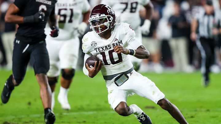 Nov 2, 2024; Columbia, South Carolina, USA; Texas A&M Aggies quarterback Marcel Reed (10) scrambles against the South Carolina Gamecocks in the second quarter at Williams-Brice Stadium. Mandatory Credit: Jeff Blake-Imagn Images