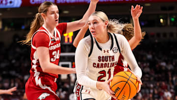 Feb 20, 2025; Columbia, South Carolina, USA; South Carolina Gamecocks forward Chloe Kitts (21) looks to pass around Arkansas Razorbacks forward Jenna Lawrence (34) in the first half at Colonial Life Arena. Mandatory Credit: Jeff Blake-Imagn Images
