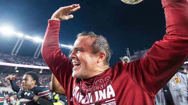 Nov 16, 2024; Columbia, South Carolina, USA; South Carolina Gamecocks head coach Shane Beamer celebrates beating the Missouri Tigers at Williams-Brice Stadium. He is holding the Mayors Cup, given to the winner of the South Carolina-Missouri game. Mandatory Credit: Jeff Blake-Imagn Images