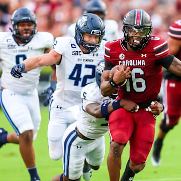 Aug 31, 2024; Columbia, South Carolina, USA; South Carolina Gamecocks quarterback LaNorris Sellers (16) is tackled by Old Dominion Monarchs safety Jahron Manning (5) in the first quarter at Williams-Brice Stadium. Mandatory Credit: Jeff Blake-Imagn Images