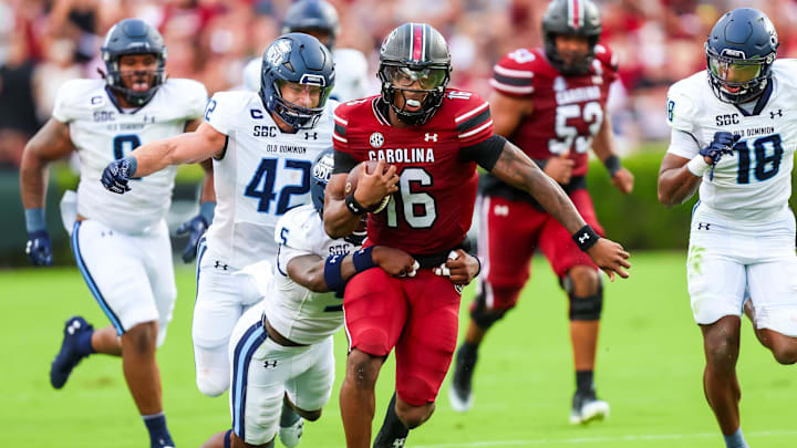 Aug 31, 2024; Columbia, South Carolina, USA; South Carolina Gamecocks quarterback LaNorris Sellers (16) is tackled by Old Dominion Monarchs safety Jahron Manning (5) in the first quarter at Williams-Brice Stadium. Mandatory Credit: Jeff Blake-Imagn Images