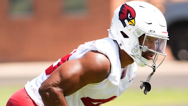 Pass rusher Benton Whitley (white uniform and helmet) goes through drills during a practice.