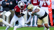 Nov 23, 2024; Columbia, South Carolina, USA; South Carolina Gamecocks running back Raheim Sanders (5) runs the ball against Wofford Terriers defensive back Javis Mynatt (11) in the first quarter at Williams-Brice Stadium. Mandatory Credit: Jeff Blake-Imagn Images