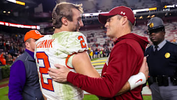 Nov 25, 2023; Columbia, South Carolina, USA; Clemson Tigers quarterback Cade Klubnik (2) and South Carolina Gamecocks head coach Shane Beamer meet after a Tigers victory at Williams-Brice Stadium. Mandatory Credit: Jeff Blake-Imagn Images