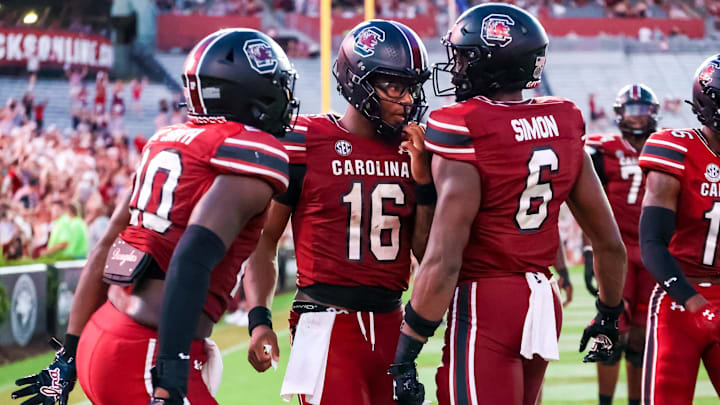 Aug 31, 2024; Columbia, South Carolina, USA; South Carolina Gamecocks quarterback Dante Reno (10), quarterback LaNorris Sellers (16) and tight end Joshua Simon (6) celebrate after a touchdown against the Old Dominion Monarchs in the second half at Williams-Brice Stadium. Mandatory Credit: Jeff Blake-Imagn Images