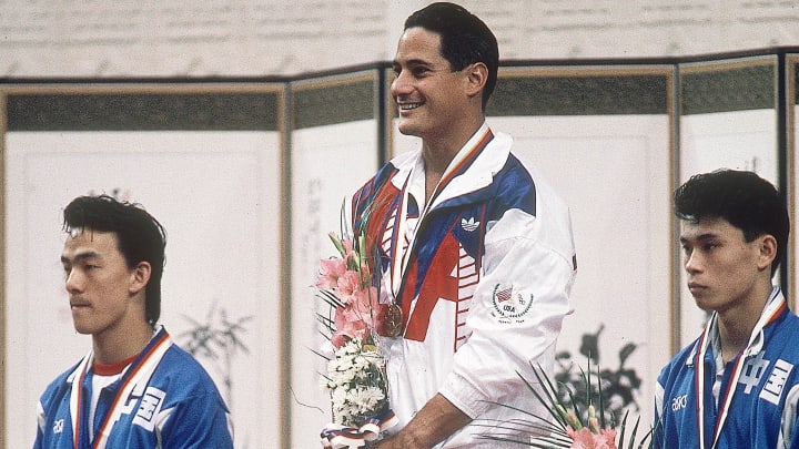 Sep 20, 1988; Seoul, SOUTH KOREA; FILE PHOTO; Greg Louganis (USA) (gold) on the podium with Tan Liangde (CHN) (silver) and Li Deliang (CHN) (bronze) after the mens 3m springboard during the 1988 Seoul Olympic Games at Jamsil Indoor Swimming Pool. Mandatory Credit: George Long-USA TODAY NETWORK