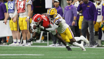 Dec 3, 2022; Atlanta, GA, USA; Georgia Bulldogs wide receiver Marcus Rosemy-Jacksaint (1) is hit following his reception by LSU Tigers linebacker Harold Perkins Jr. (40) during the second quarter at Mercedes-Benz Stadium. Mandatory Credit: Brett Davis-USA TODAY Sports