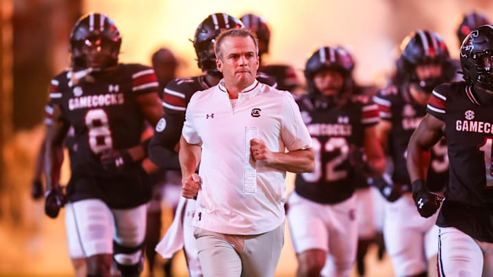 Sep 27, 2025; Columbia, South Carolina, USA; South Carolina Gamecocks head coach Shane Beamer leads his team onto the field during the Gamecocks 2001 entrance before their game against the Kentucky Wildcats at Williams-Brice Stadium. Mandatory Credit: Jeff Blake-Imagn Images