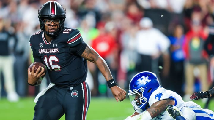 Nov 18, 2023; Columbia, South Carolina, USA; South Carolina Gamecocks quarterback LaNorris Sellers (16) rushes past Kentucky Wildcats defensive back Zion Childress (11) in the first quarter at Williams-Brice Stadium. Mandatory Credit: Jeff Blake-USA TODAY Sports Kentucky