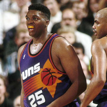 Phoenix Suns forward Charles Barkley (34) talks to Oliver Miller (25) against the Portland Trail Blazers at Memorial Coliseum in 1992.