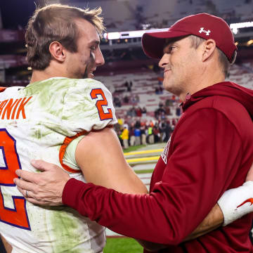 Nov 25, 2023; Columbia, South Carolina, USA; Clemson Tigers quarterback Cade Klubnik (2) and South Carolina Gamecocks head coach Shane Beamer meet after a Tigers victory at Williams-Brice Stadium. Mandatory Credit: Jeff Blake-USA TODAY Sports