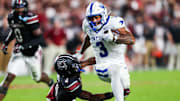 Kentucky Wildcats running back Seth McGowan (3) gets past South Carolina Gamecocks defensive back Vicari Swain (4) on his way to a touchdown in the first quarter at Williams-Brice Stadium.