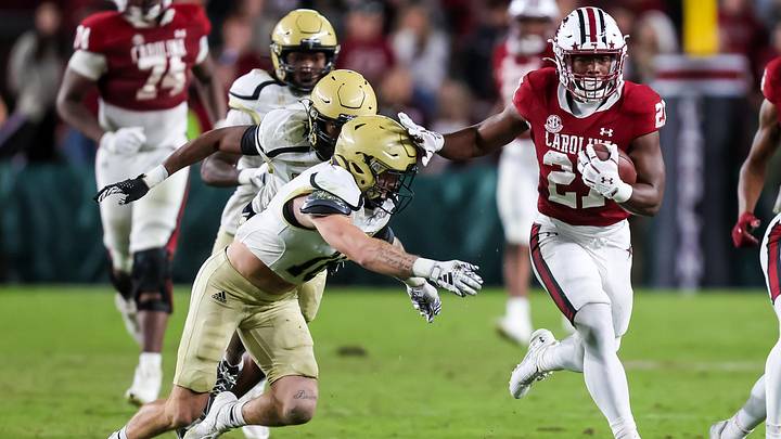 Nov 23, 2024; Columbia, South Carolina, USA; South Carolina Gamecocks running back Oscar Adaway III (27) runs the ball against the Wofford Terriers in the second half at Williams-Brice Stadium. Mandatory Credit: Jeff Blake-Imagn Images