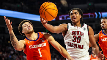 Dec 17, 2024; Columbia, South Carolina, USA; South Carolina Gamecocks forward Collin Murray-Boyles (30) grabs a rebound in front of Clemson Tigers guard Chase Hunter (1) in the first half at Colonial Life Arena. Mandatory Credit: Jeff Blake-Imagn Images