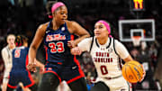 Feb 4, 2024; Columbia, South Carolina, USA; South Carolina Gamecocks guard Te-Hina Paopao (0) drives around Ole Miss Rebels forward Kharyssa Richardson (33) in the first half at Colonial Life Arena. Mandatory Credit: Jeff Blake-Imagn Images