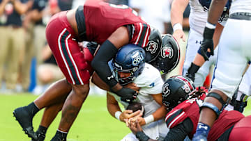 South Carolina football EDGE teaming up with Kyle Kennard and Monkell Goodwine for a tackle on Saturday