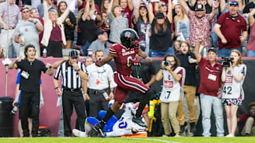 South Carolina football tight end Josh Simon running over Florida DB Miguel Mitchell on his way to a touchdown in 2023.
