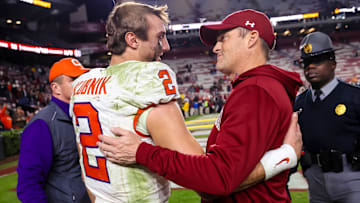 Nov 25, 2023; Columbia, South Carolina, USA; Clemson Tigers quarterback Cade Klubnik (2) and South Carolina Gamecocks head coach Shane Beamer meet after a Tigers victory at Williams-Brice Stadium. Mandatory Credit: Jeff Blake-Imagn Images