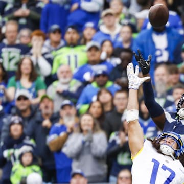 Nov 3, 2024; Seattle, Washington, USA; Seattle Seahawks cornerback Riq Woolen (27) intercepts a pass intended for Los Angeles Rams wide receiver Puka Nacua (17) during the second quarter at Lumen Field. Nacua was ejected following the play. Mandatory Credit: Joe Nicholson-Imagn Images