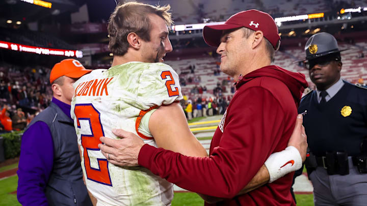 Nov 25, 2023; Columbia, South Carolina, USA; Clemson Tigers quarterback Cade Klubnik (2) and South Carolina Gamecocks head coach Shane Beamer meet after a Tigers victory at Williams-Brice Stadium. Mandatory Credit: Jeff Blake-Imagn Images