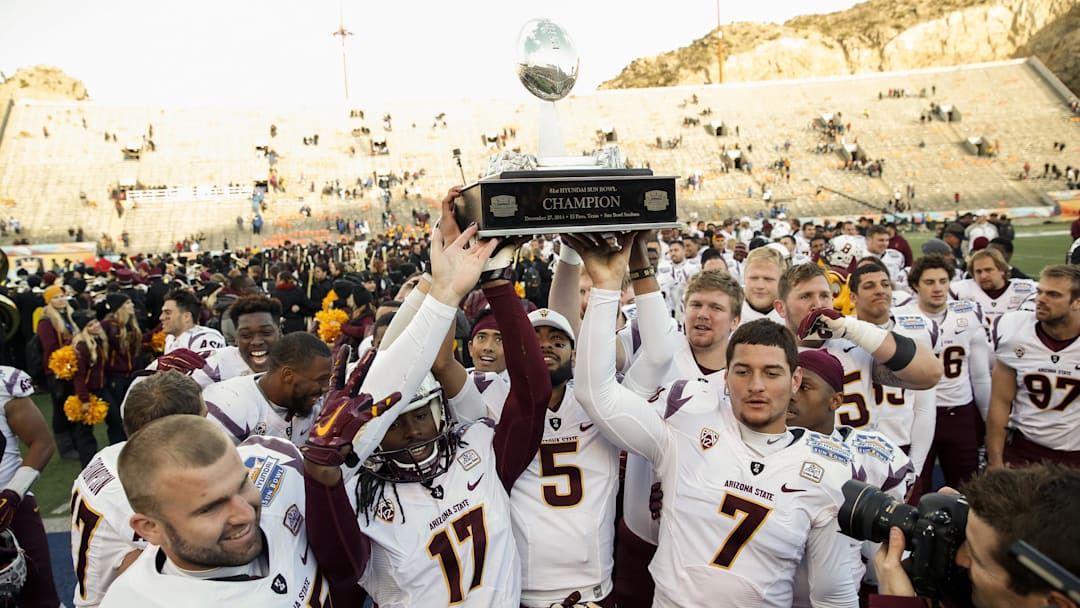 Dec 27, 2014; El Paso, TX, USA; Arizona State players hold up the Hyundai Sun Bowl Trophy after winning the 2014 Sun Bowl at Sun Bowl Stadium. The Sun Devils defeated the Blue Devils 36-31. Mandatory Credit: Ivan Pierre Aguirre-Imagn Images